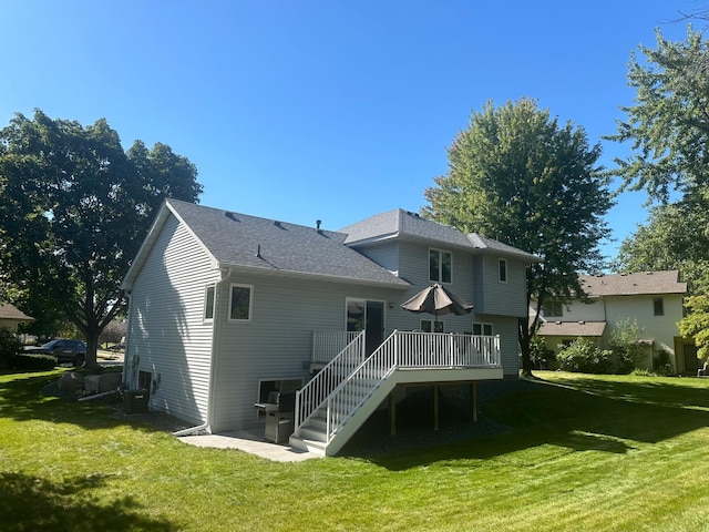 back of property with a wooden deck and a yard