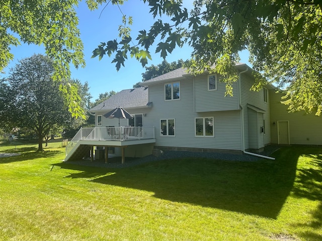 rear view of property featuring a lawn and a wooden deck