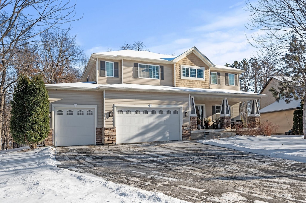 view of front of house featuring a porch and a garage