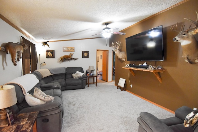 living room with carpet flooring, a textured ceiling, ceiling fan, and crown molding