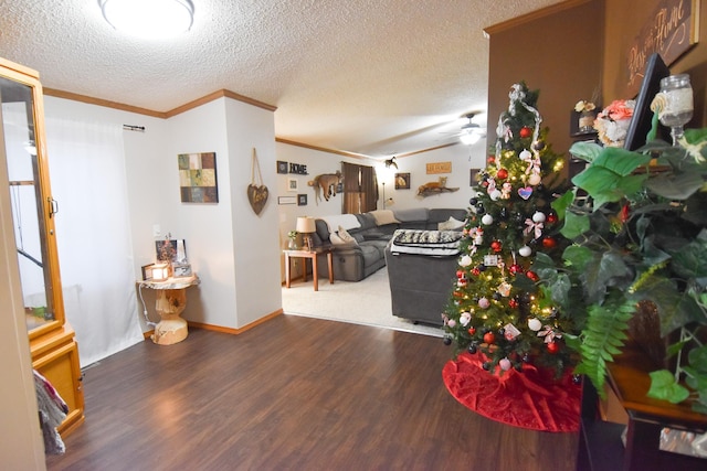 living room featuring a textured ceiling, hardwood / wood-style floors, ceiling fan, and crown molding