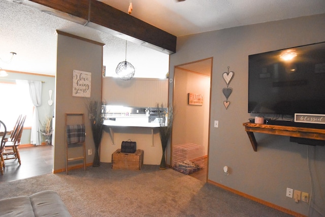 carpeted living room with beamed ceiling