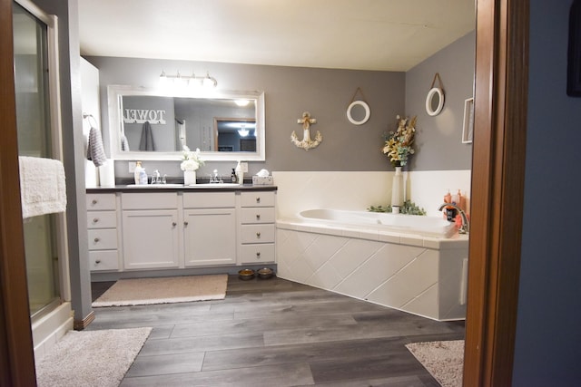 bathroom featuring wood-type flooring, vanity, and independent shower and bath