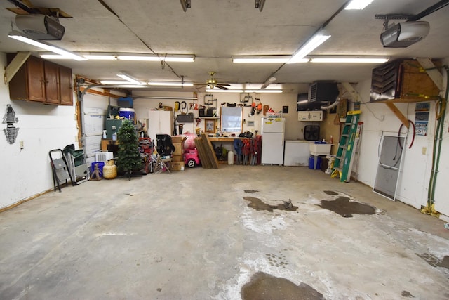 garage with white fridge, a garage door opener, and a workshop area