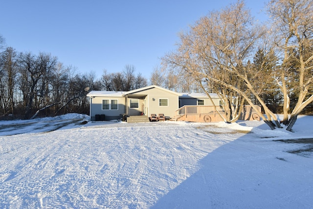 view of snow covered rear of property