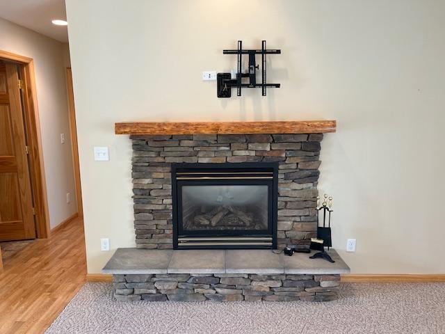 room details featuring a fireplace and wood-type flooring