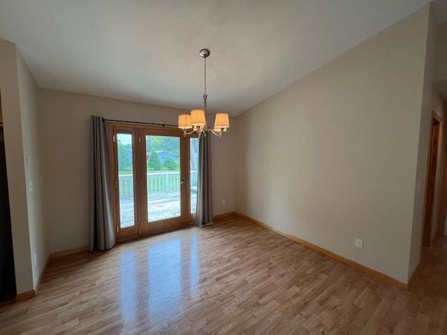 unfurnished dining area featuring a notable chandelier and light wood-type flooring