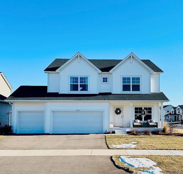 view of front of house with a front yard and a garage