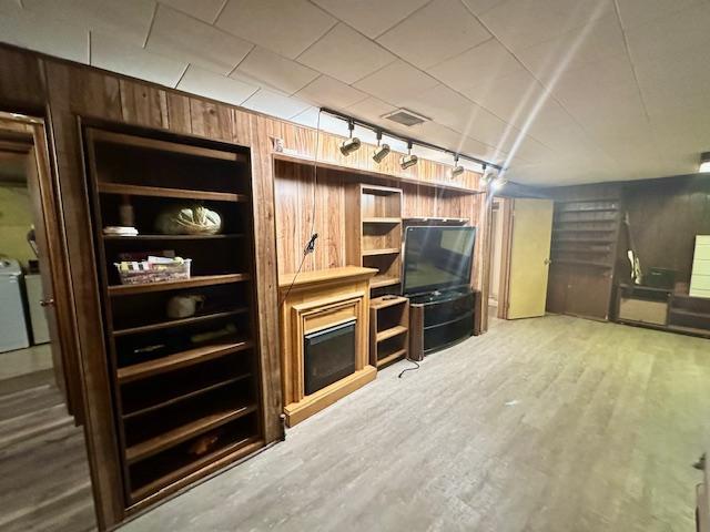 interior space featuring hardwood / wood-style floors and wood walls