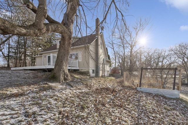 view of snow covered exterior with a deck