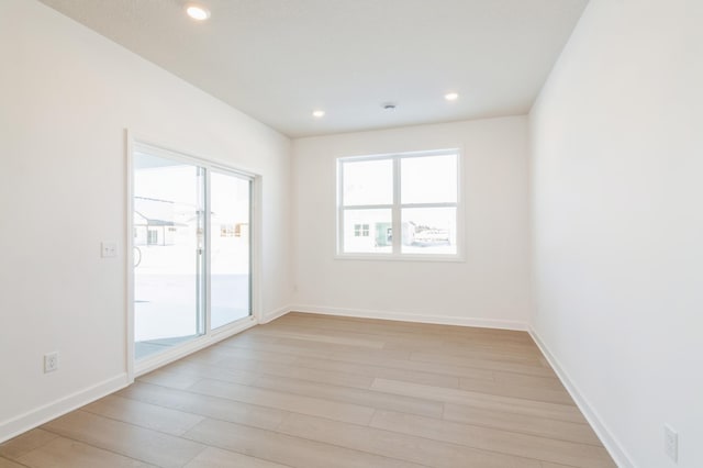 unfurnished room with light wood-type flooring and a healthy amount of sunlight