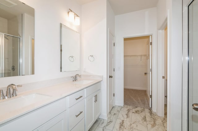 bathroom featuring an enclosed shower and vanity