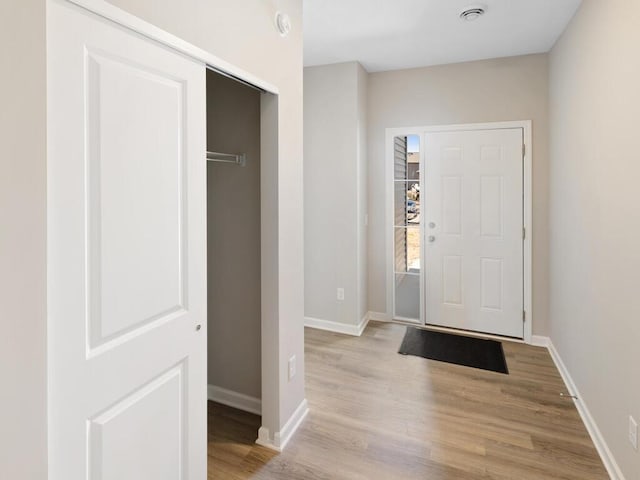 foyer entrance with light hardwood / wood-style floors