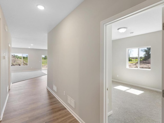 hallway with light colored carpet