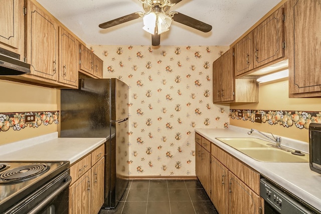 kitchen featuring ceiling fan, black appliances, sink, dark tile patterned floors, and a textured ceiling