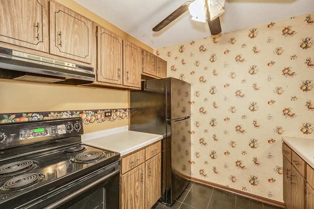 kitchen featuring a textured ceiling, dark tile patterned flooring, and black appliances