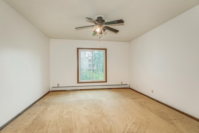 spare room featuring light carpet, ceiling fan, and a baseboard radiator