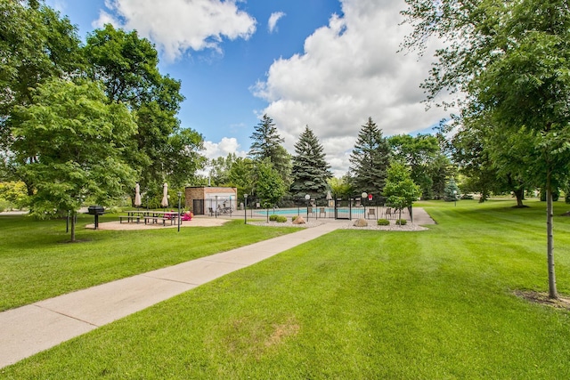 view of community with a pool and a lawn