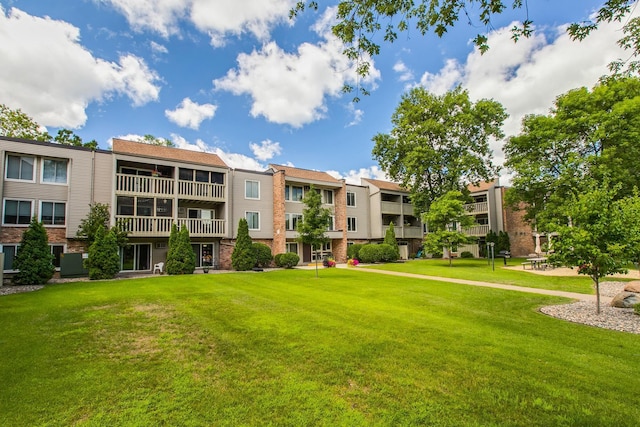 view of home's community with a lawn