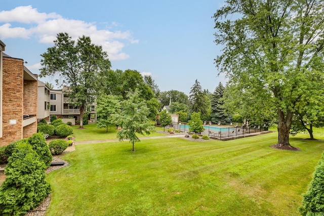 view of home's community with a lawn and a swimming pool