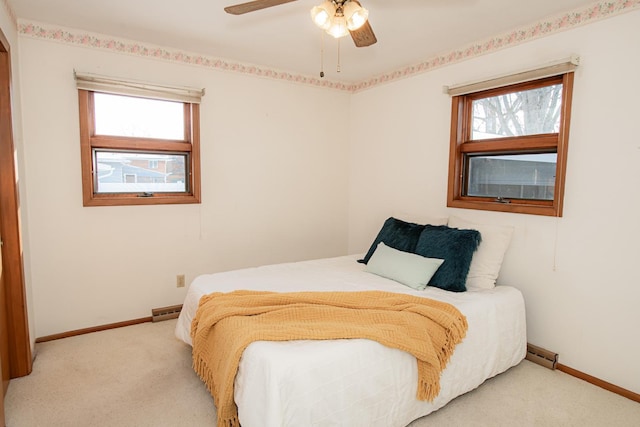 bedroom featuring ceiling fan and light carpet