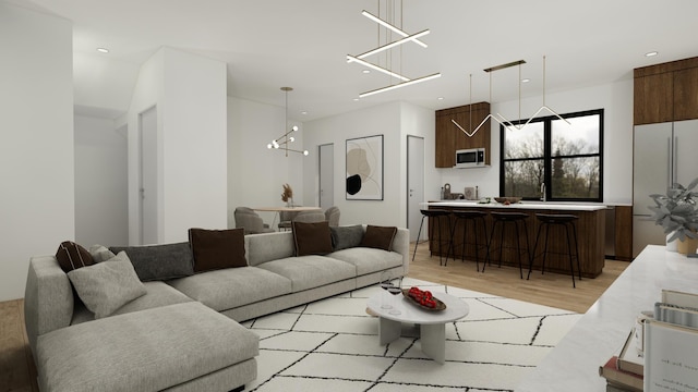 living room featuring a chandelier and light hardwood / wood-style floors