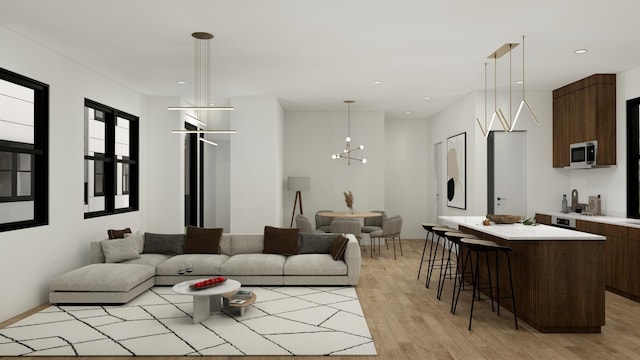 living room with light wood-type flooring and a notable chandelier