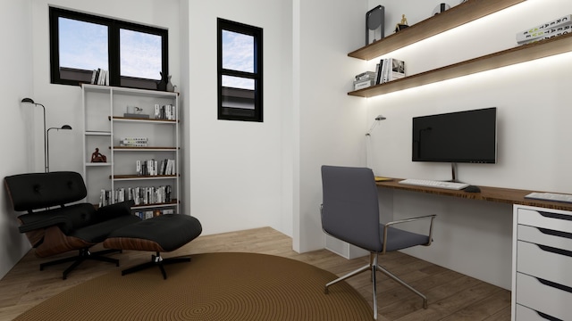 office area with built in desk and light hardwood / wood-style floors