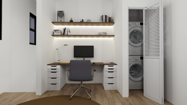 office space with stacked washing maching and dryer and light hardwood / wood-style floors