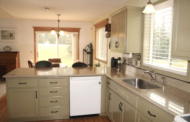 kitchen featuring dishwasher, sink, hanging light fixtures, kitchen peninsula, and light stone countertops