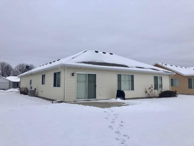 snow covered property featuring central air condition unit