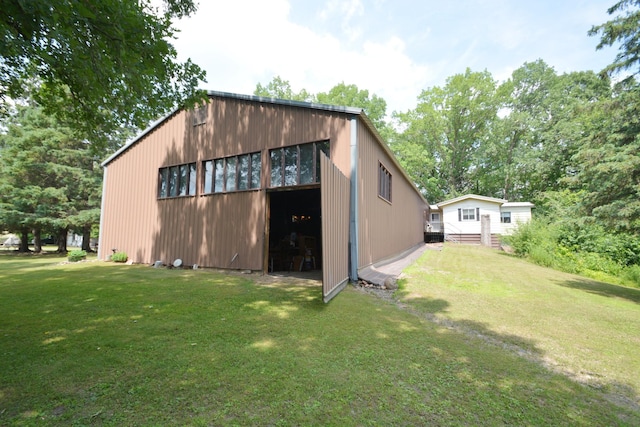 view of outdoor structure featuring a lawn