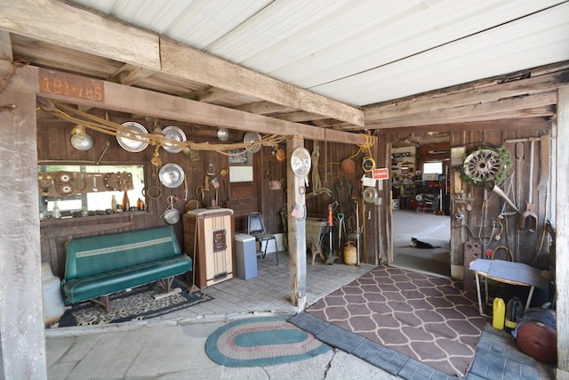 miscellaneous room featuring wood walls and a workshop area