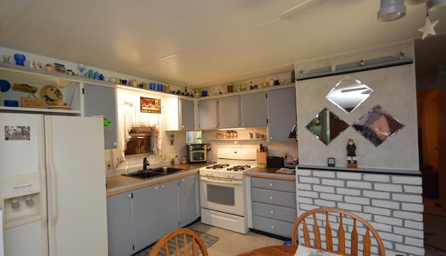 kitchen with sink, white appliances, and gray cabinets