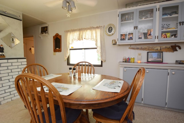 carpeted dining room featuring ceiling fan