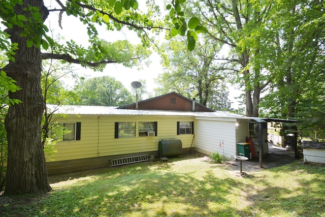 rear view of house with a lawn