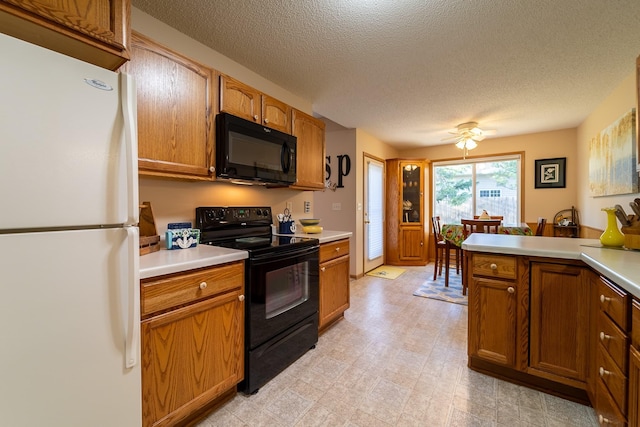 kitchen featuring black appliances, light countertops, and brown cabinets