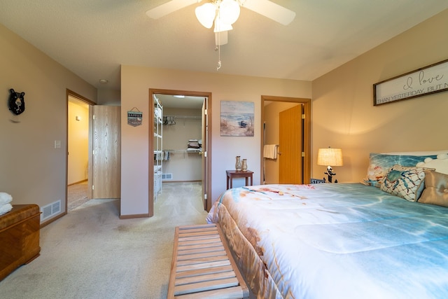 bedroom featuring a closet, visible vents, a spacious closet, carpet flooring, and baseboards