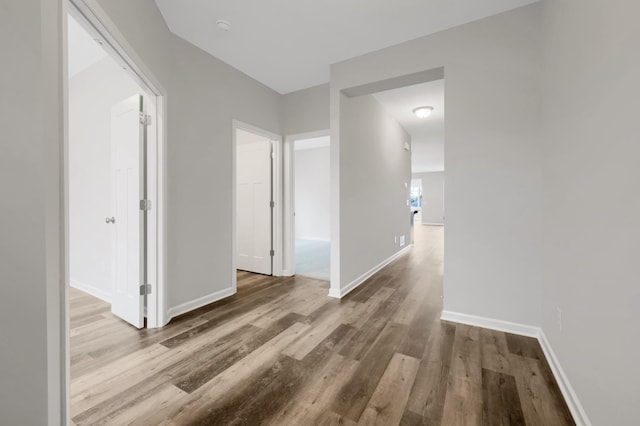 corridor with wood-type flooring