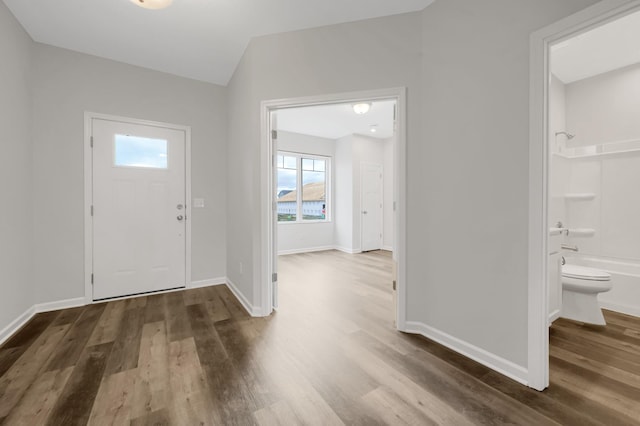 entryway featuring wood finished floors and baseboards