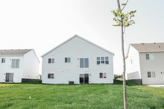 back of house featuring a lawn and central AC unit