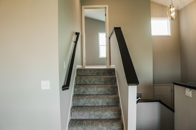 stairway with lofted ceiling and a healthy amount of sunlight