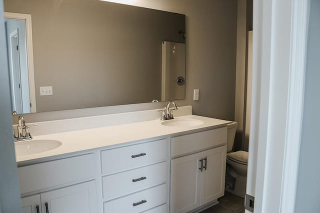 bathroom with a shower, vanity, and toilet