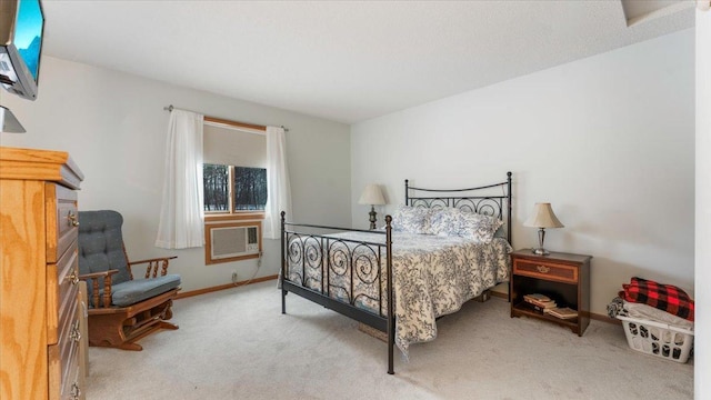 carpeted bedroom featuring a wall unit AC and baseboards