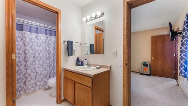 bathroom with curtained shower, vanity, and toilet