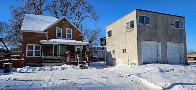 view of front of property featuring covered porch and a garage