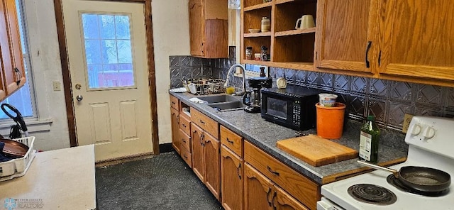 kitchen featuring sink, decorative backsplash, and white electric range oven