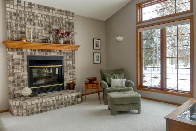 sitting room with lofted ceiling, a fireplace, and carpet floors