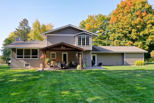 back of house with a lawn and a patio area