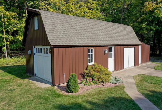 view of outbuilding featuring a lawn and a garage